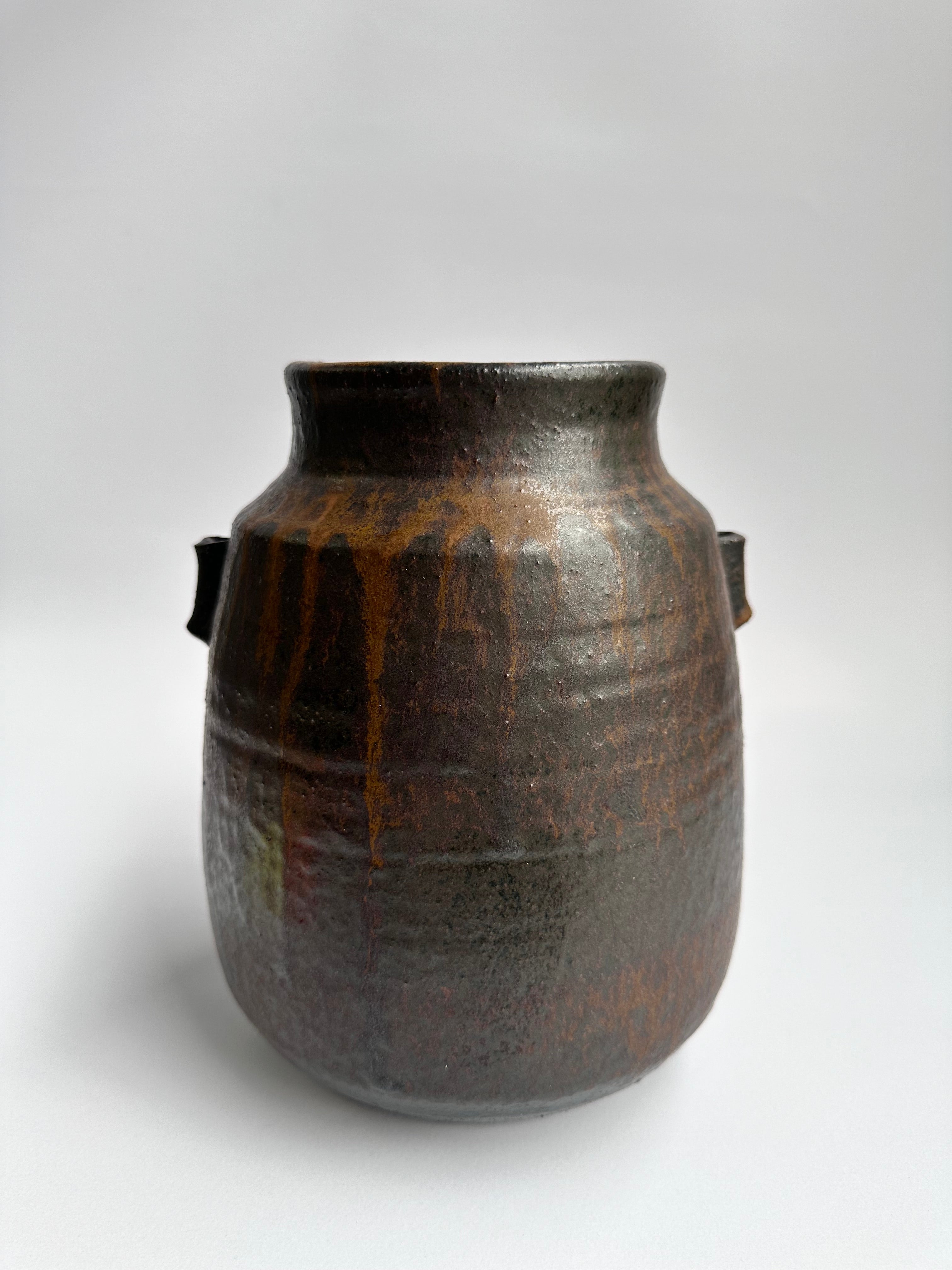 Brown ceramic jar on a white background
