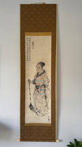 Traditional Japanese artwork of a person in a kimono on a wall hanging