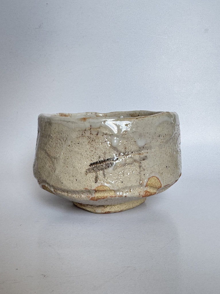 Small ceramic bowl with a textured surface on a white background