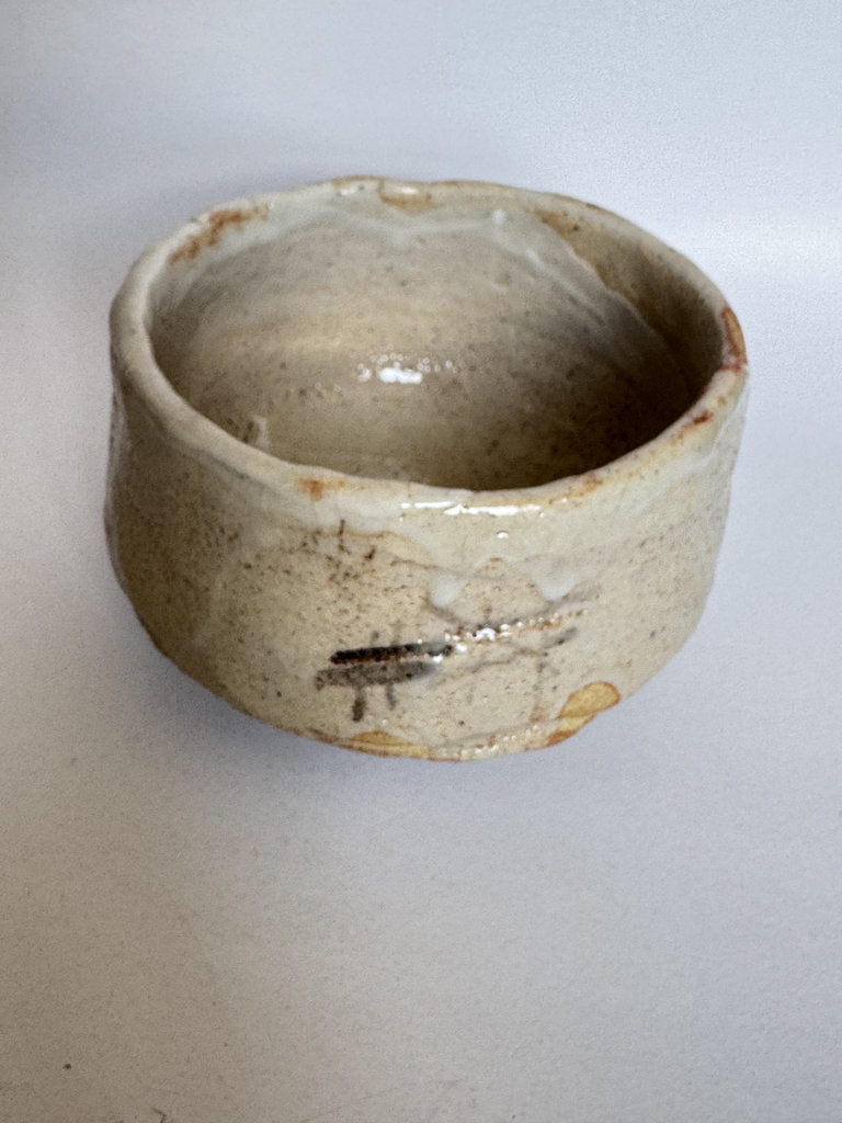 Small ceramic bowl with a textured surface on a plain background