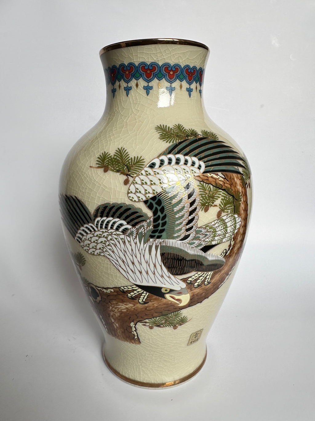 Ceramic vase with bird and floral design on a white background
