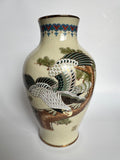 Ceramic vase with bird and floral design on a white background