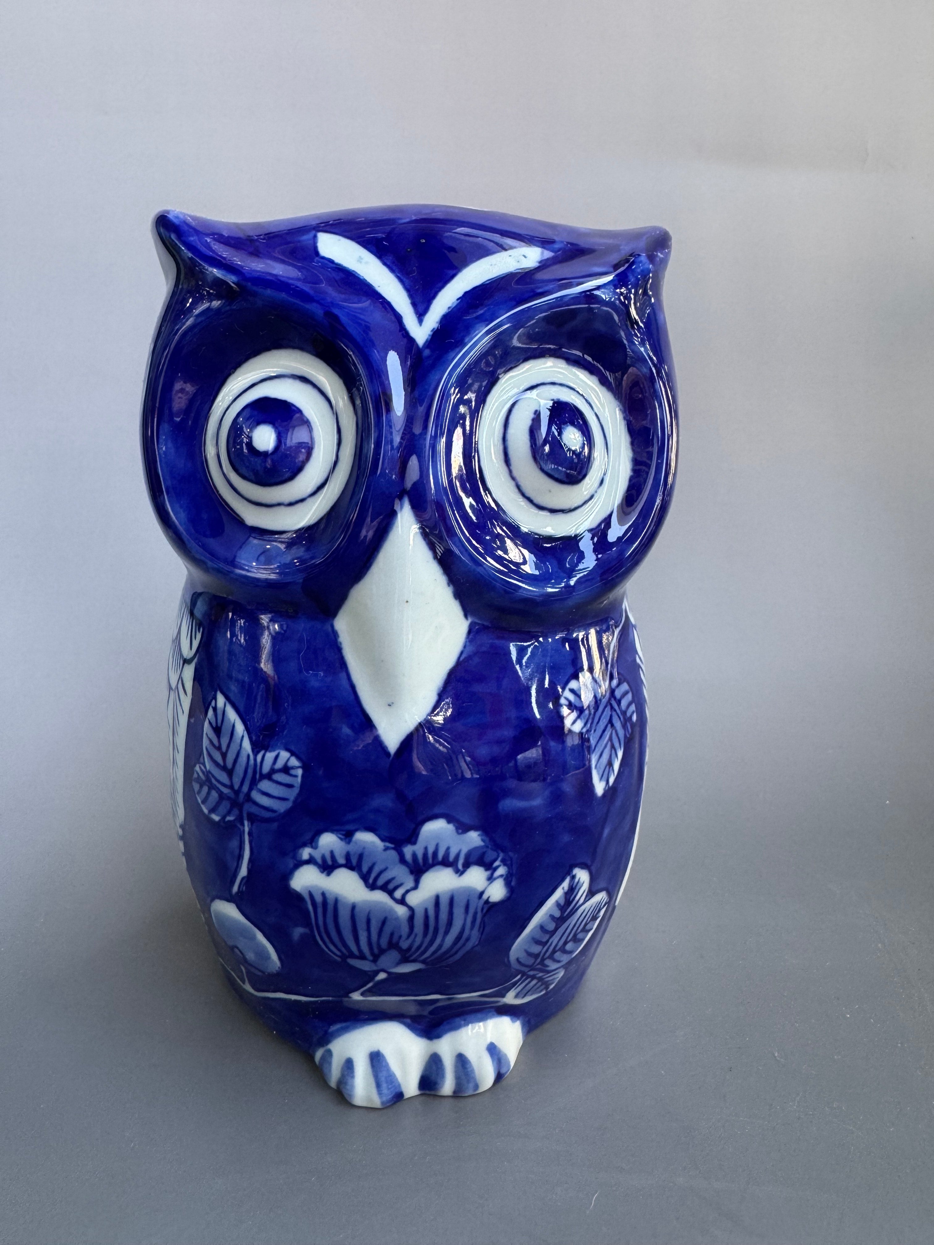 Blue and white ceramic owl on a gray background