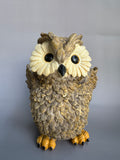 Decorative owl figurine on a gray background