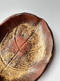 Close-up of a ceramic plate with a star design on a white background