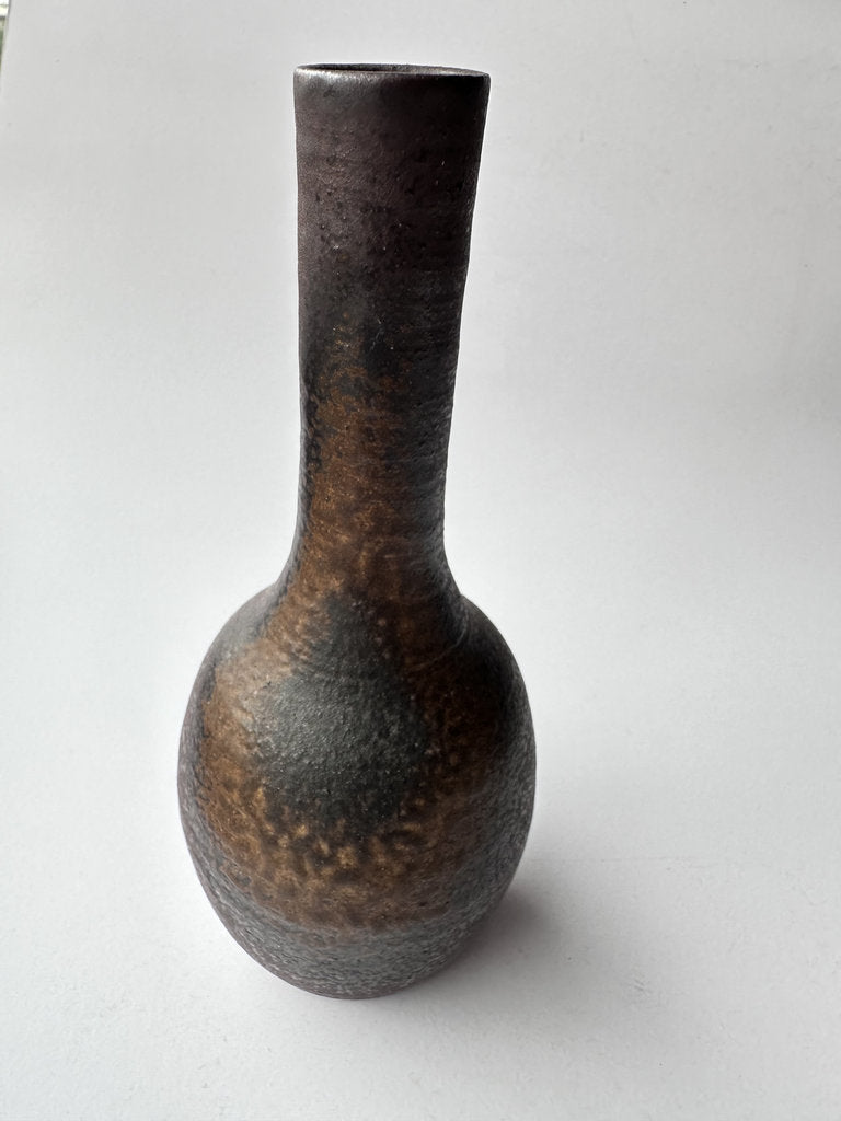 Textured ceramic vase on a white background