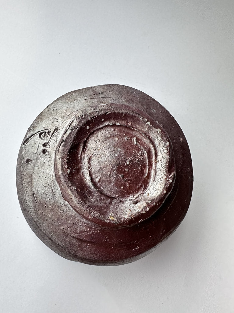 Top view of a ceramic bowl with a textured surface on a light gray background