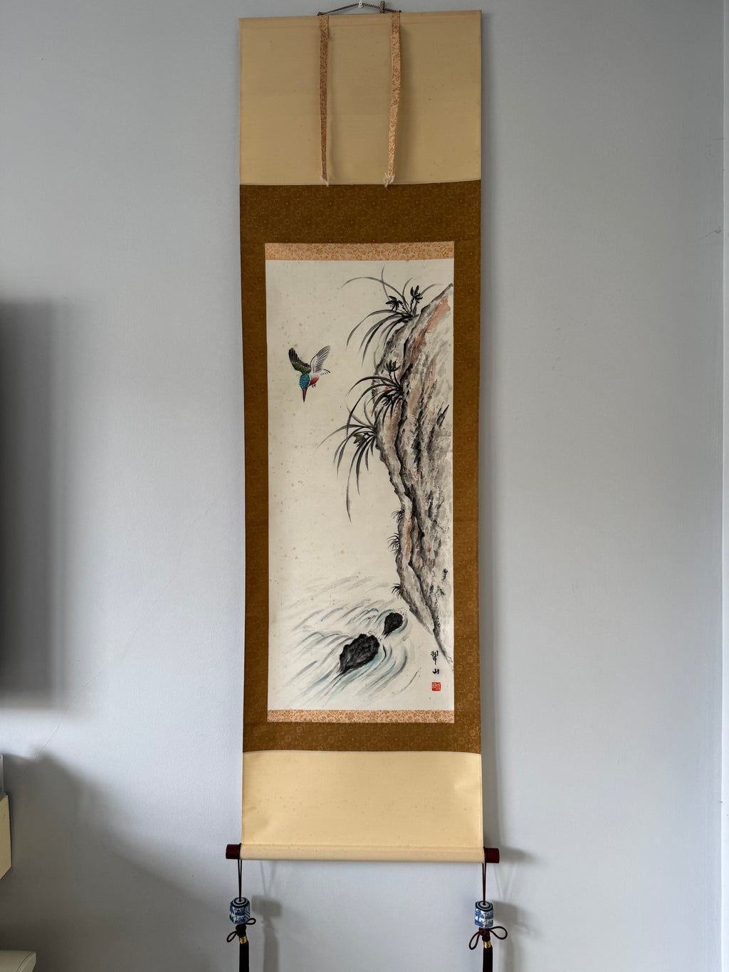 Traditional scroll art on a plain wall