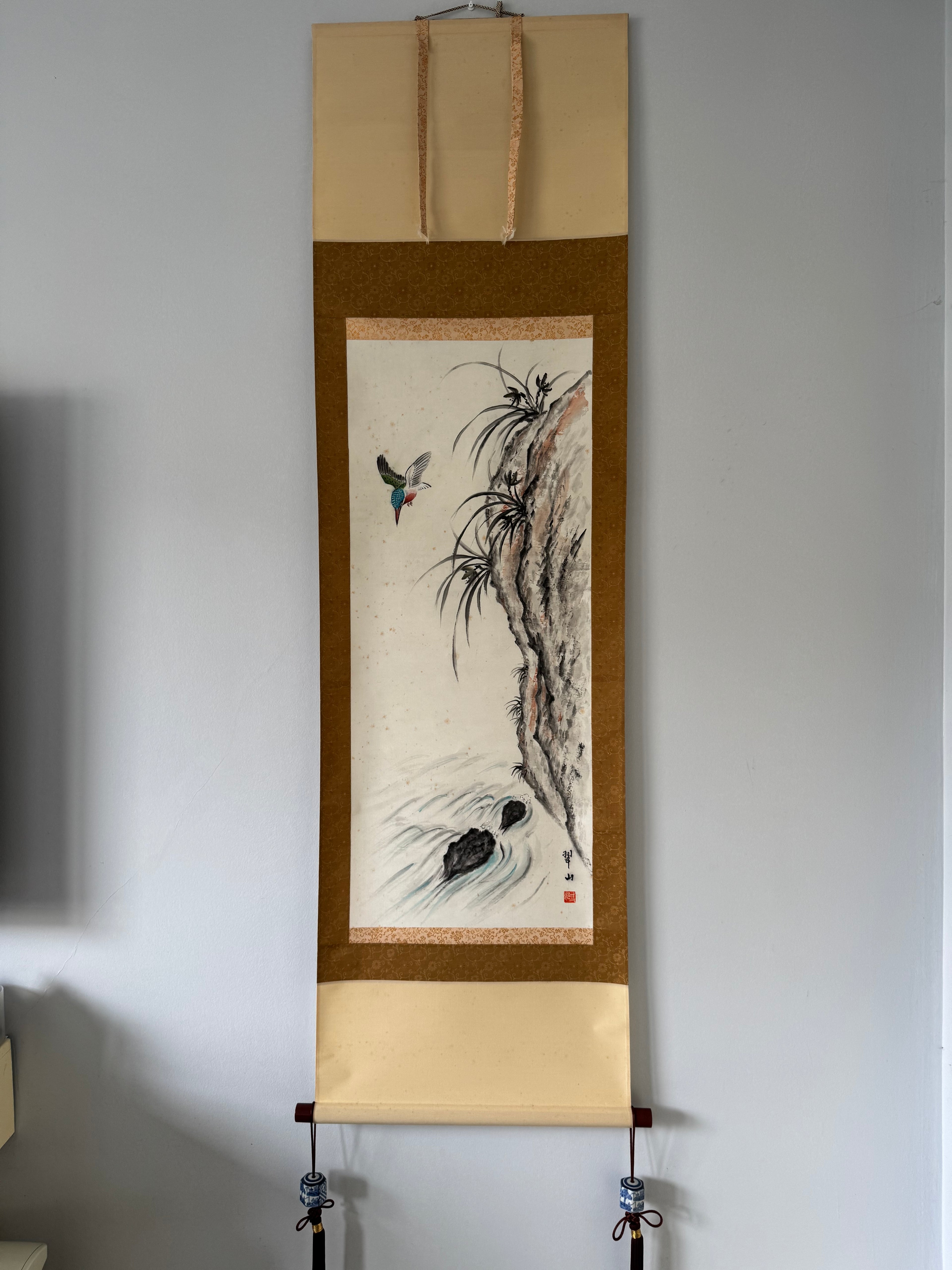 Traditional scroll art on a plain wall