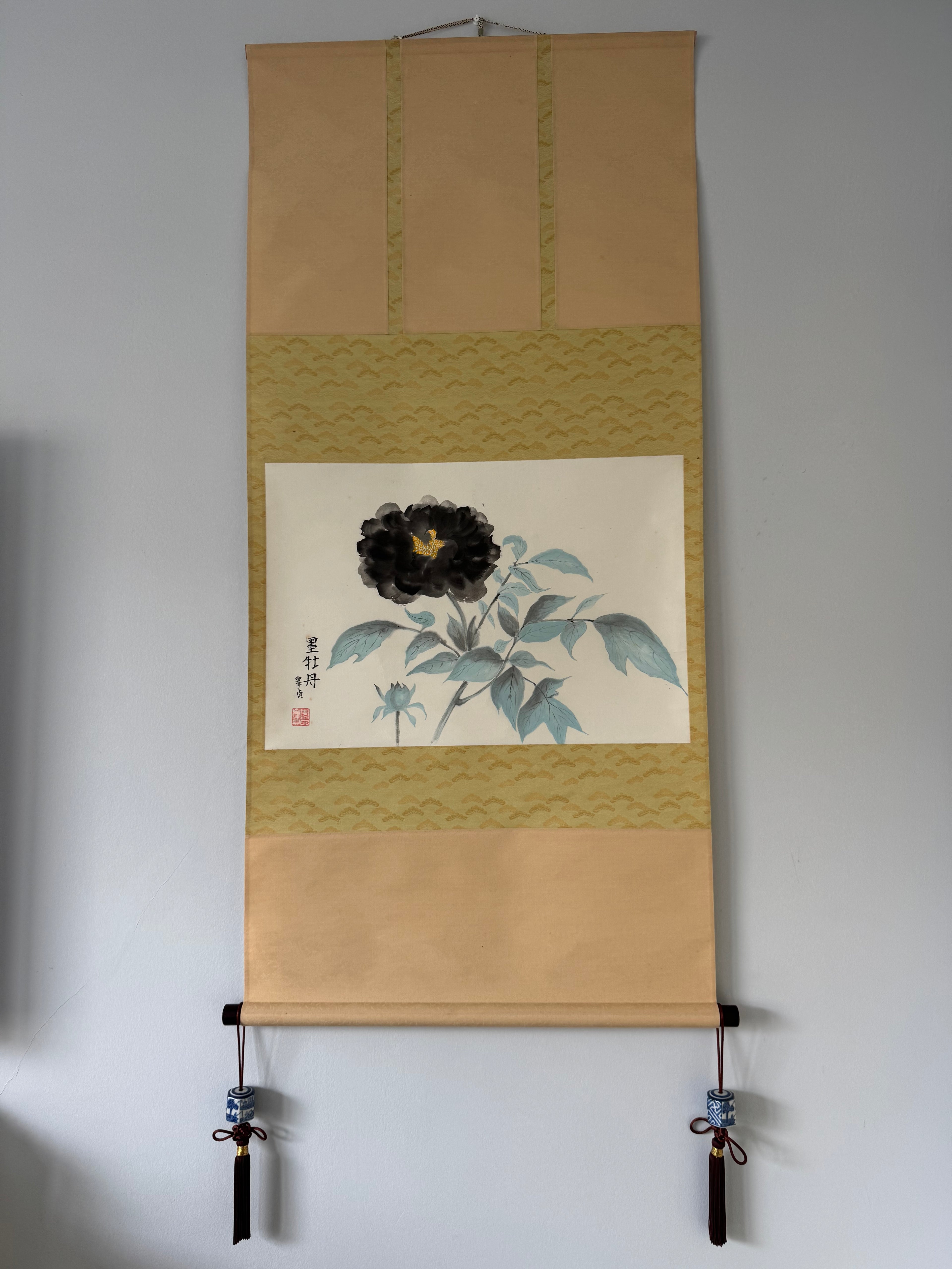 Traditional Japanese scroll with floral design on a plain background