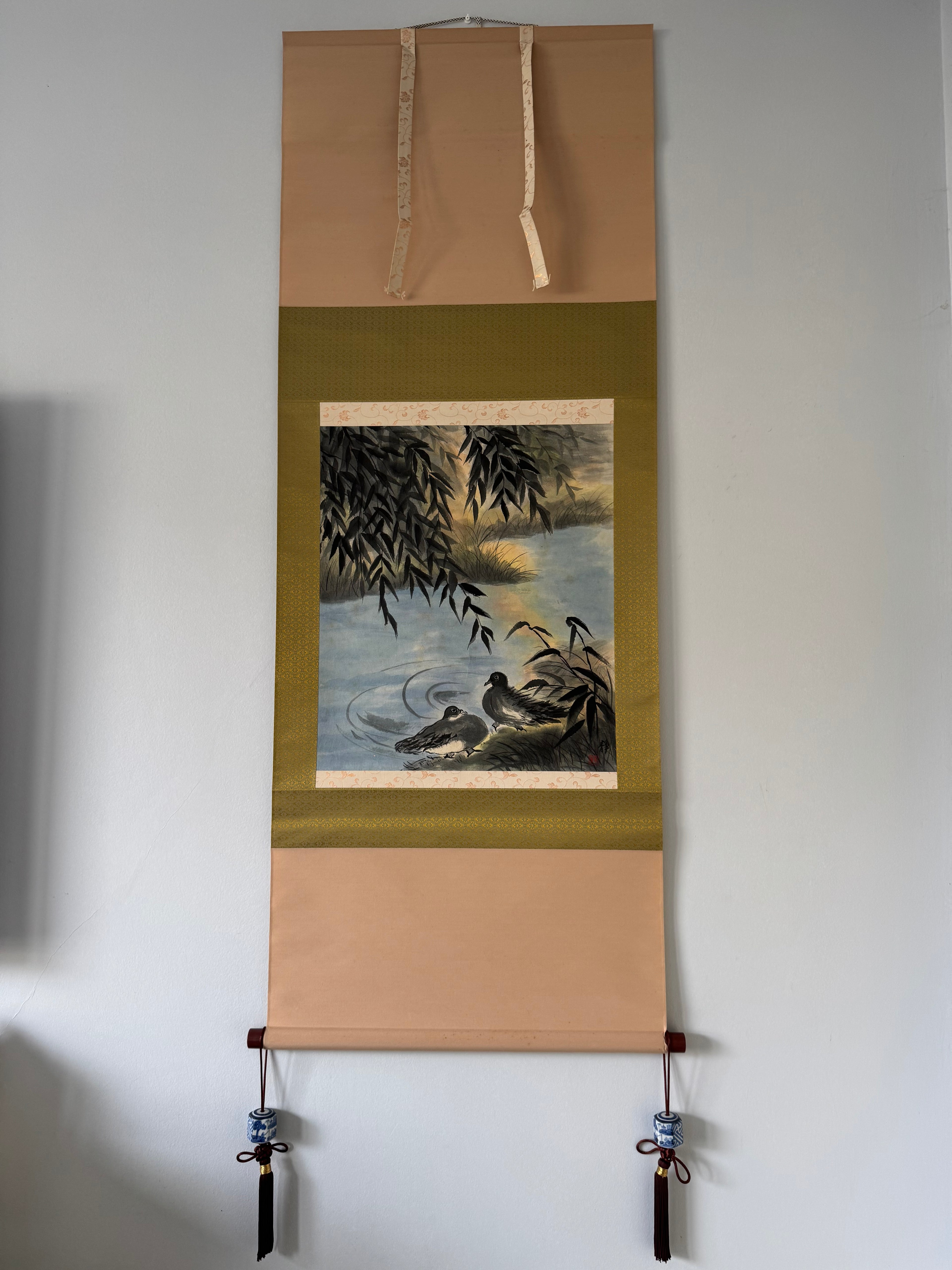 Roll of artwork with a landscape design on a white wall