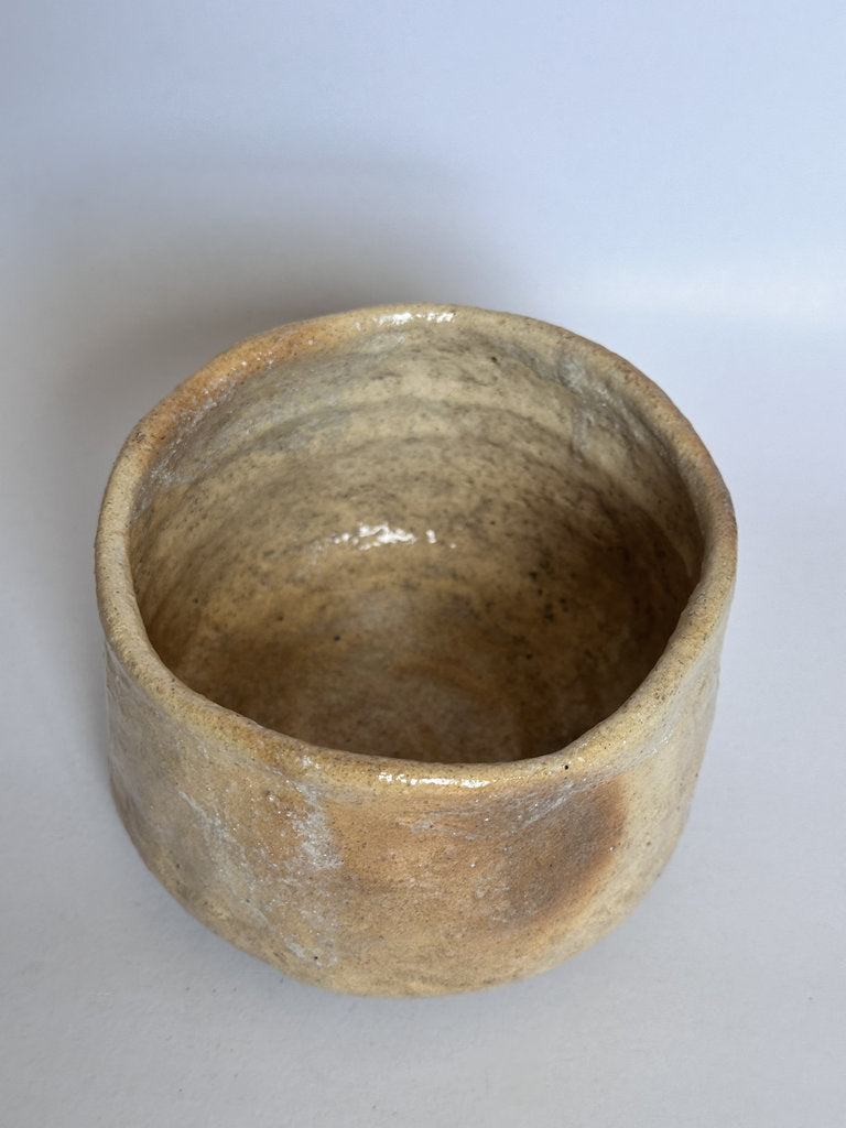 Brown ceramic bowl on a light gray background