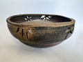 bizen Ceramic ikebana with decorative cutouts on a light background