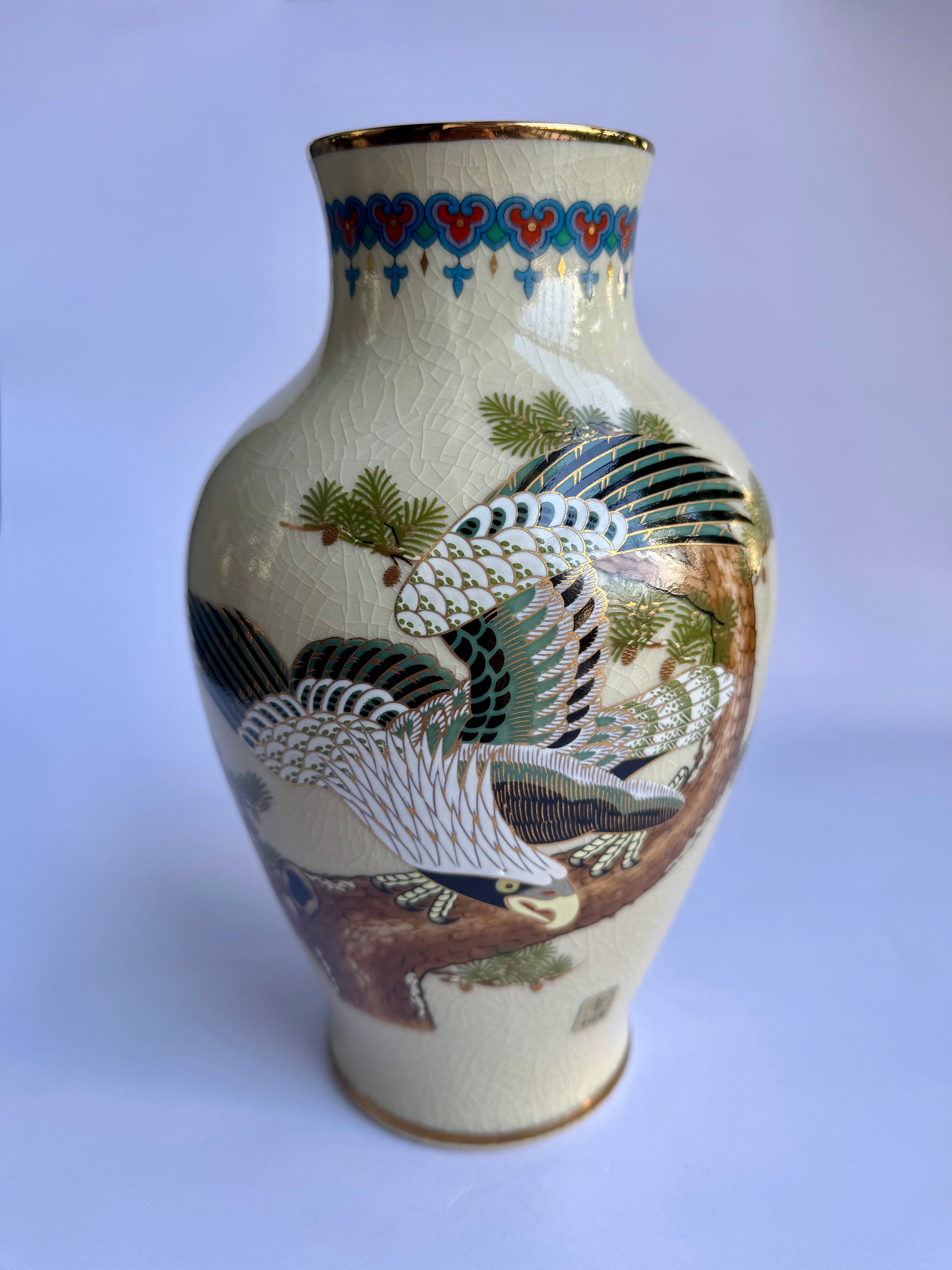 Decorative vase with bird and floral patterns on a white background