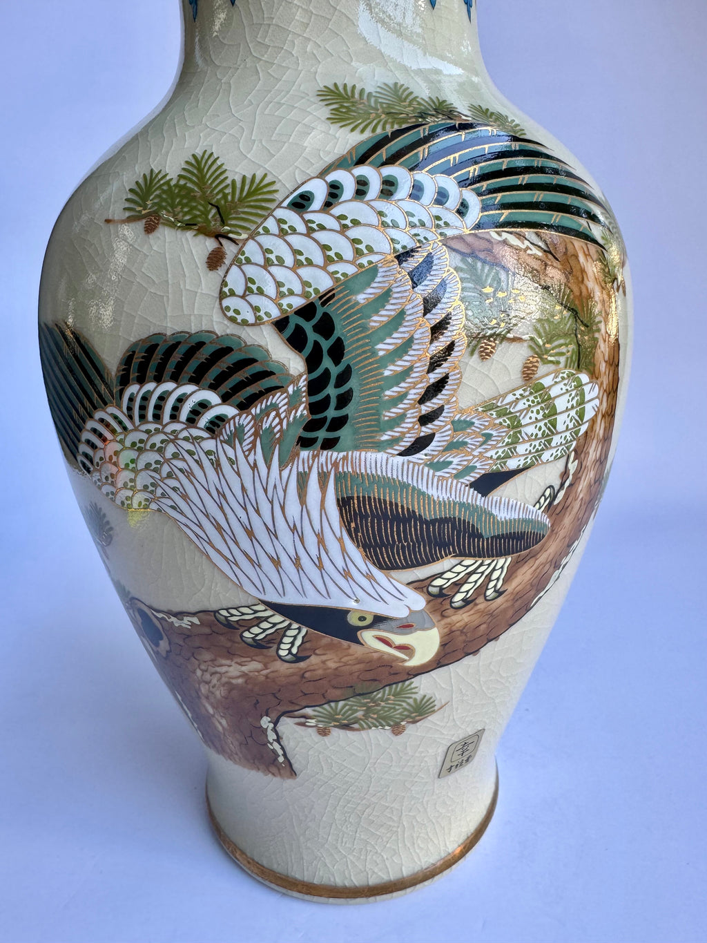 Ceramic vase with bird and nature design on a white background