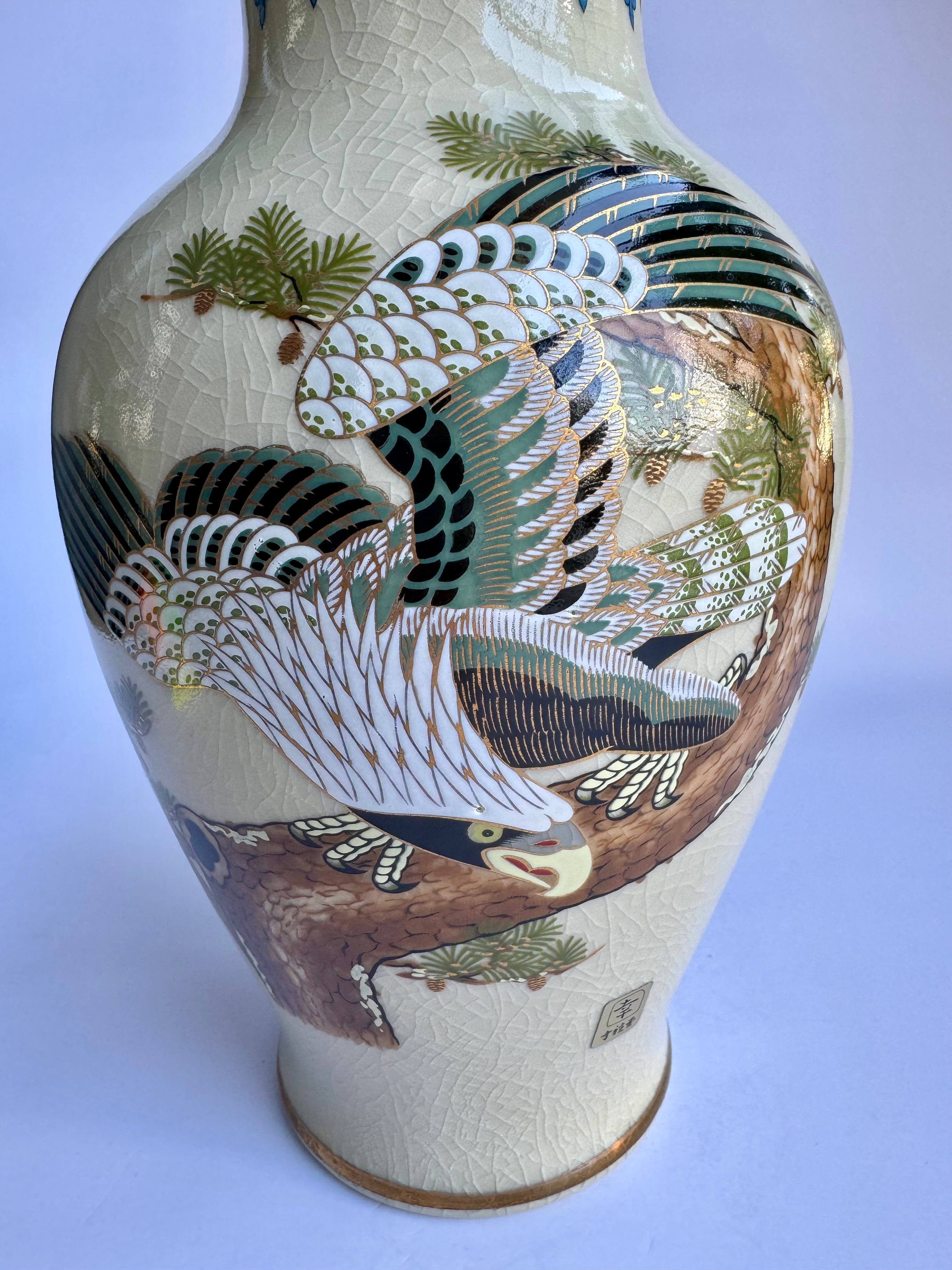 Ceramic vase with bird and nature design on a white background