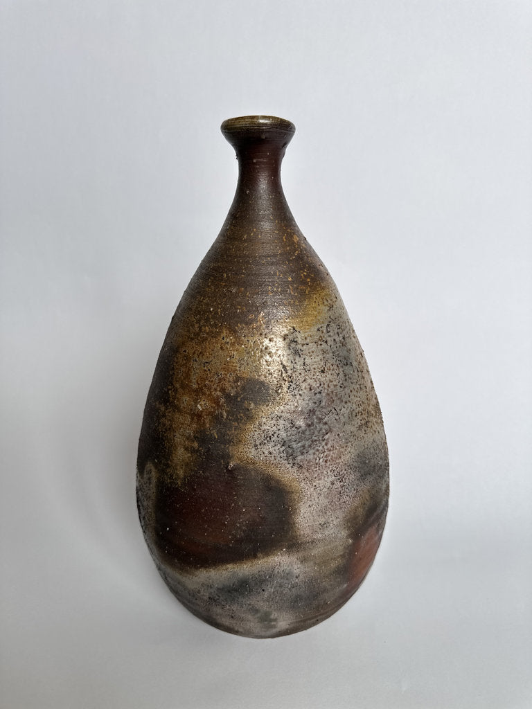 Brown ceramic vase on a light gray background