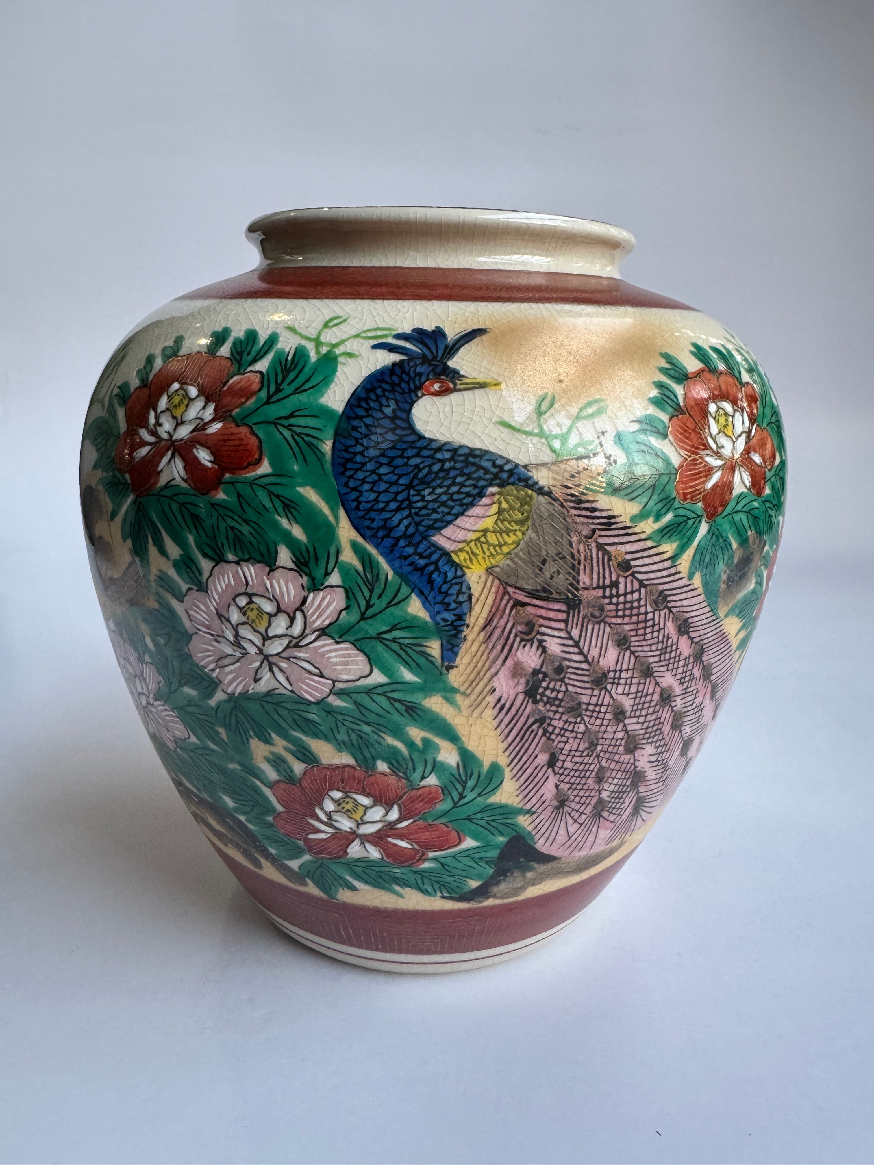 Decorative ceramic bowl with peacock and floral design on a white background