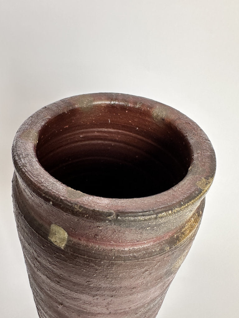 Terracotta pot with a textured surface on a white background