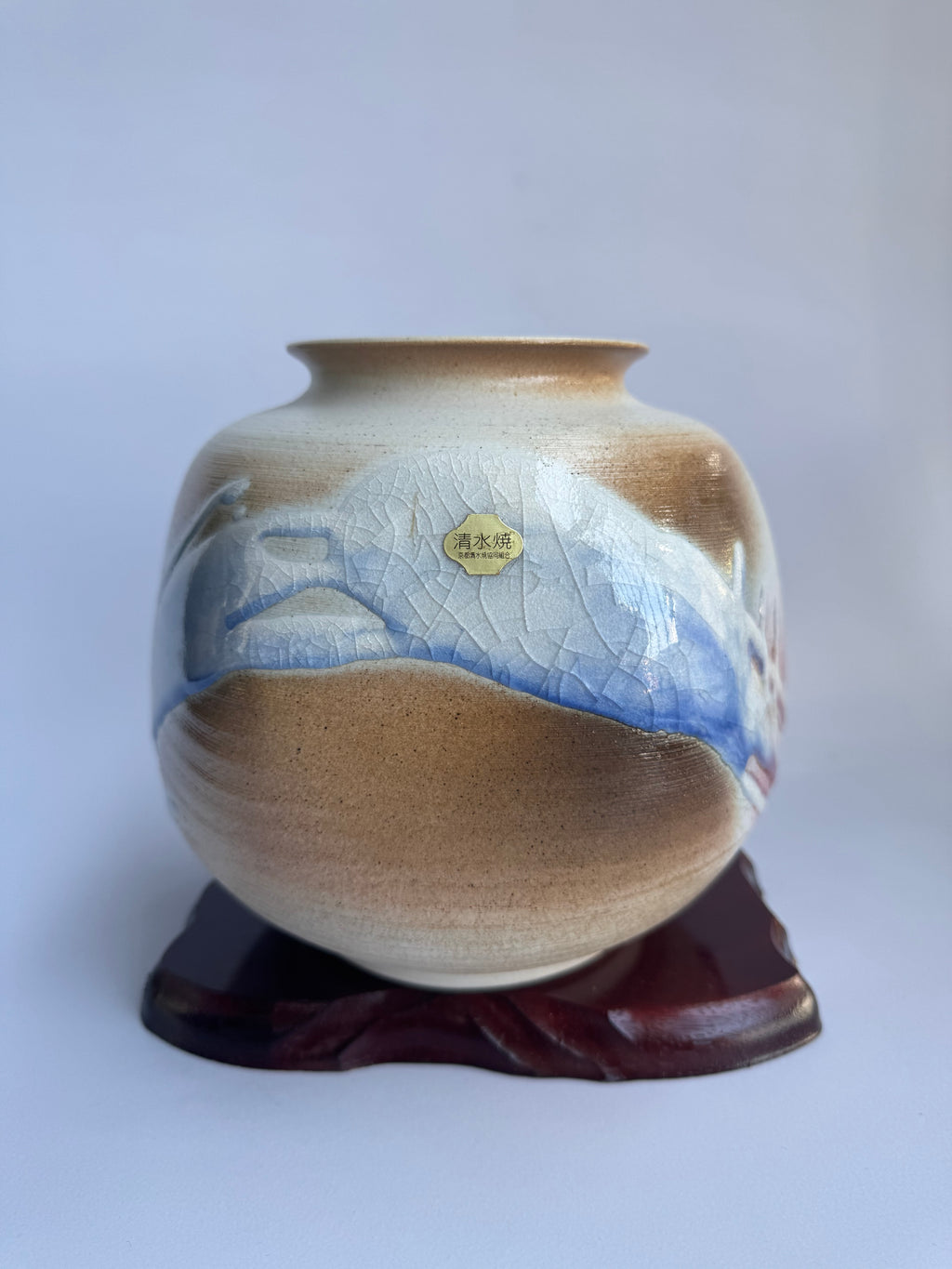 “Contemporary Japanese ceramic vase featuring flowing river motif.”