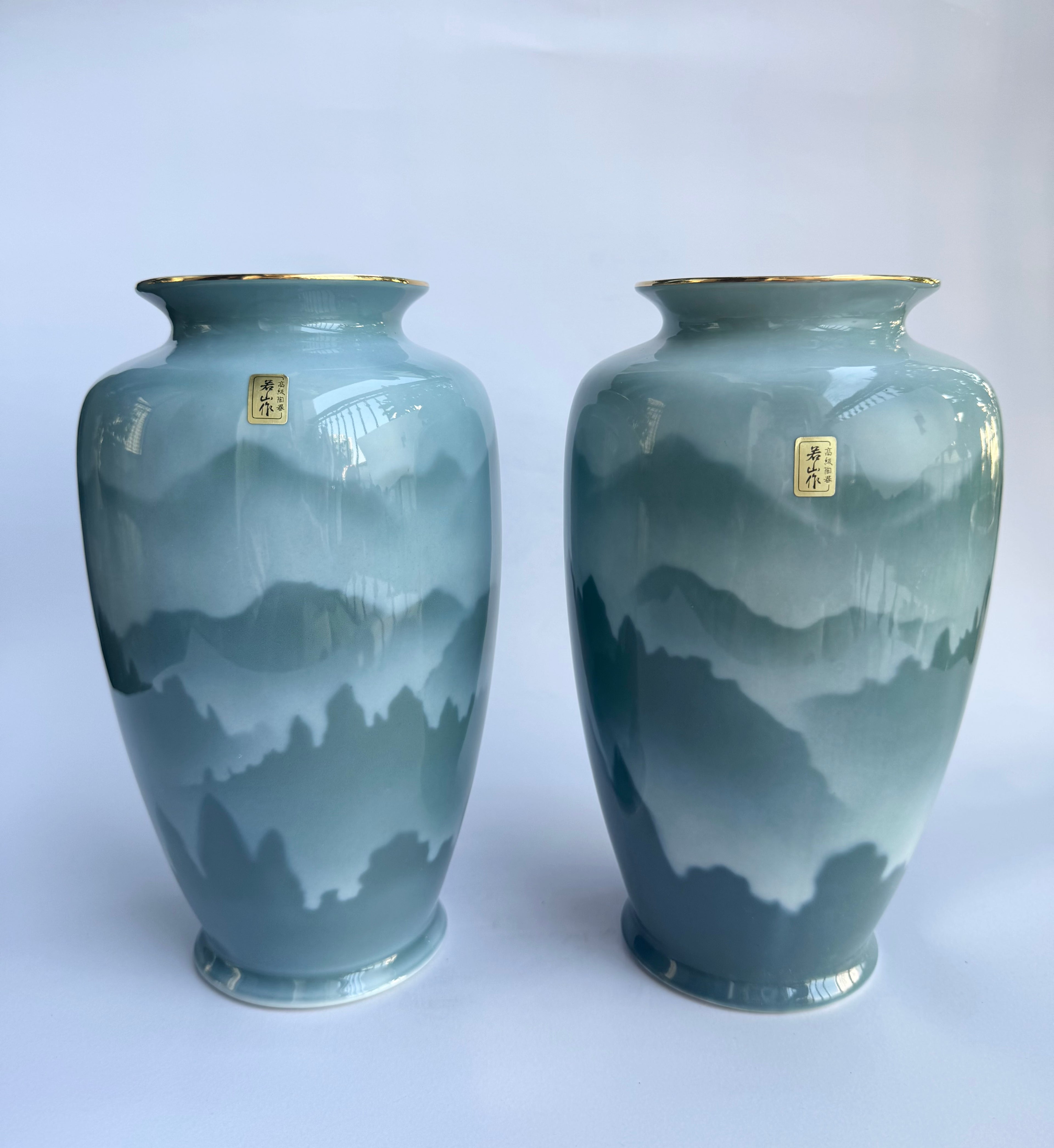 Two ceramic vases with mountain landscape design 