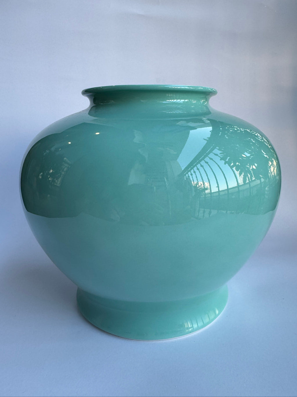 Green ceramic vase on a white background
