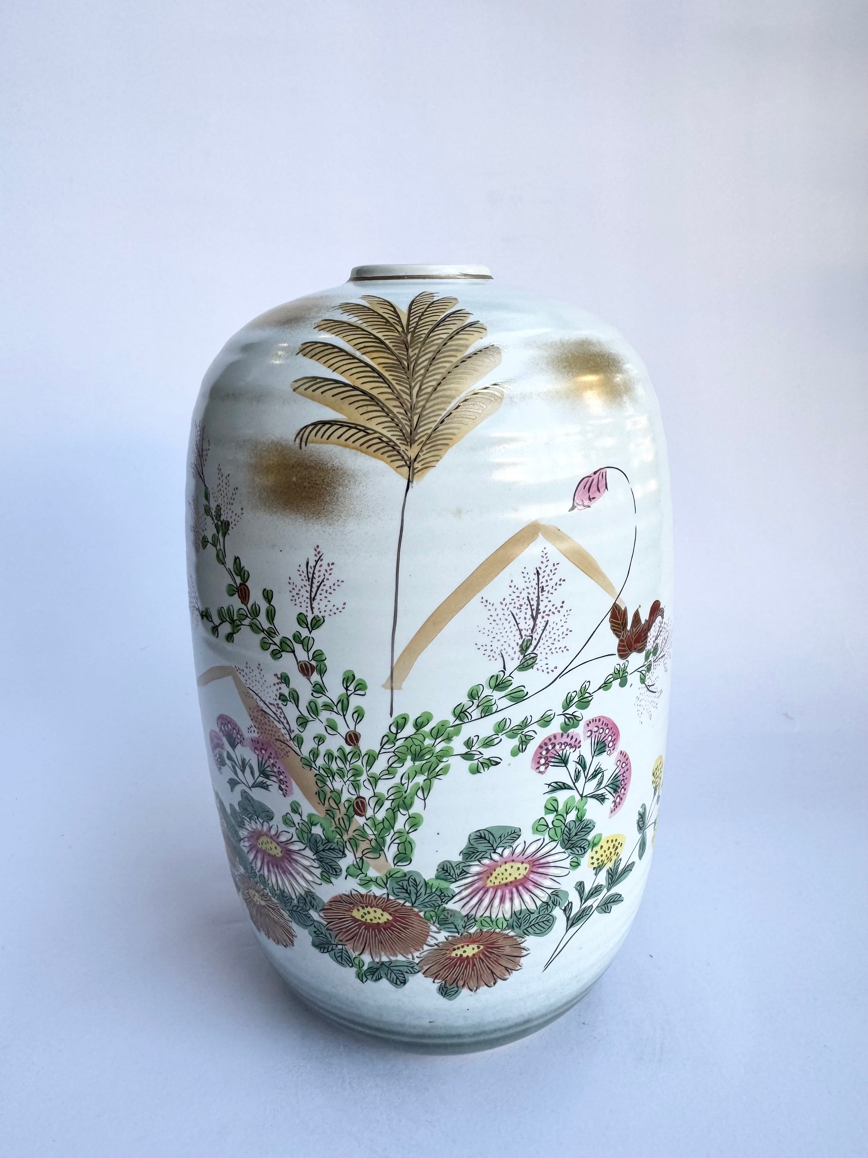 Decorative vase with floral and leaf patterns on a white background
