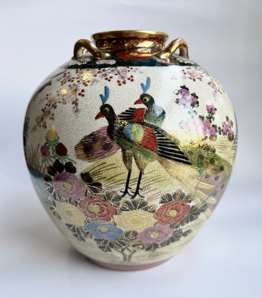 Decorative vase with bird and floral design on a white background