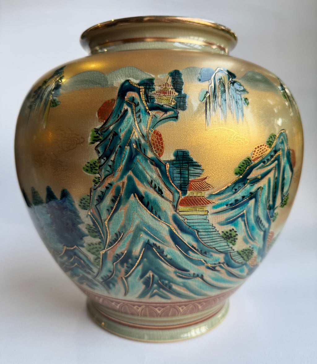 Decorative vase with mountain and landscape design on a white background