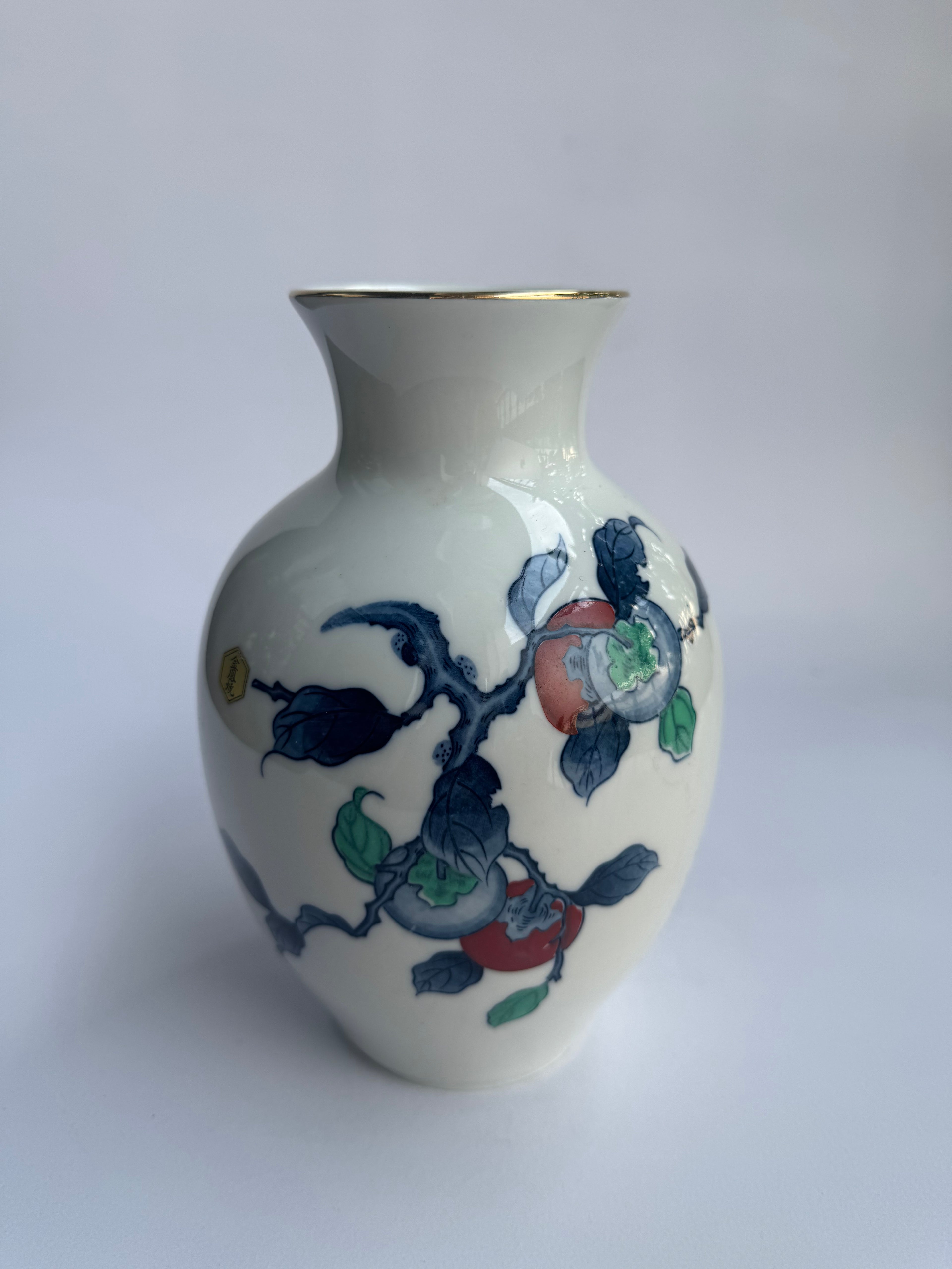 Decorative ceramic vase with floral design on a white background
