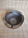 Ceramic ashtray on a woven mat