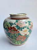 Decorative ceramic vase with floral patterns on a white background