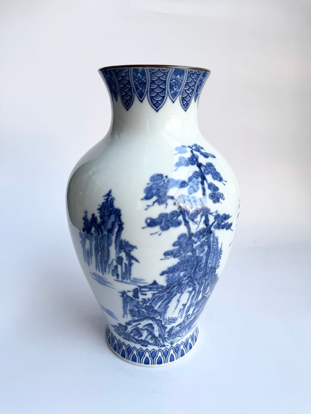 White vase with blue floral patterns on a white background