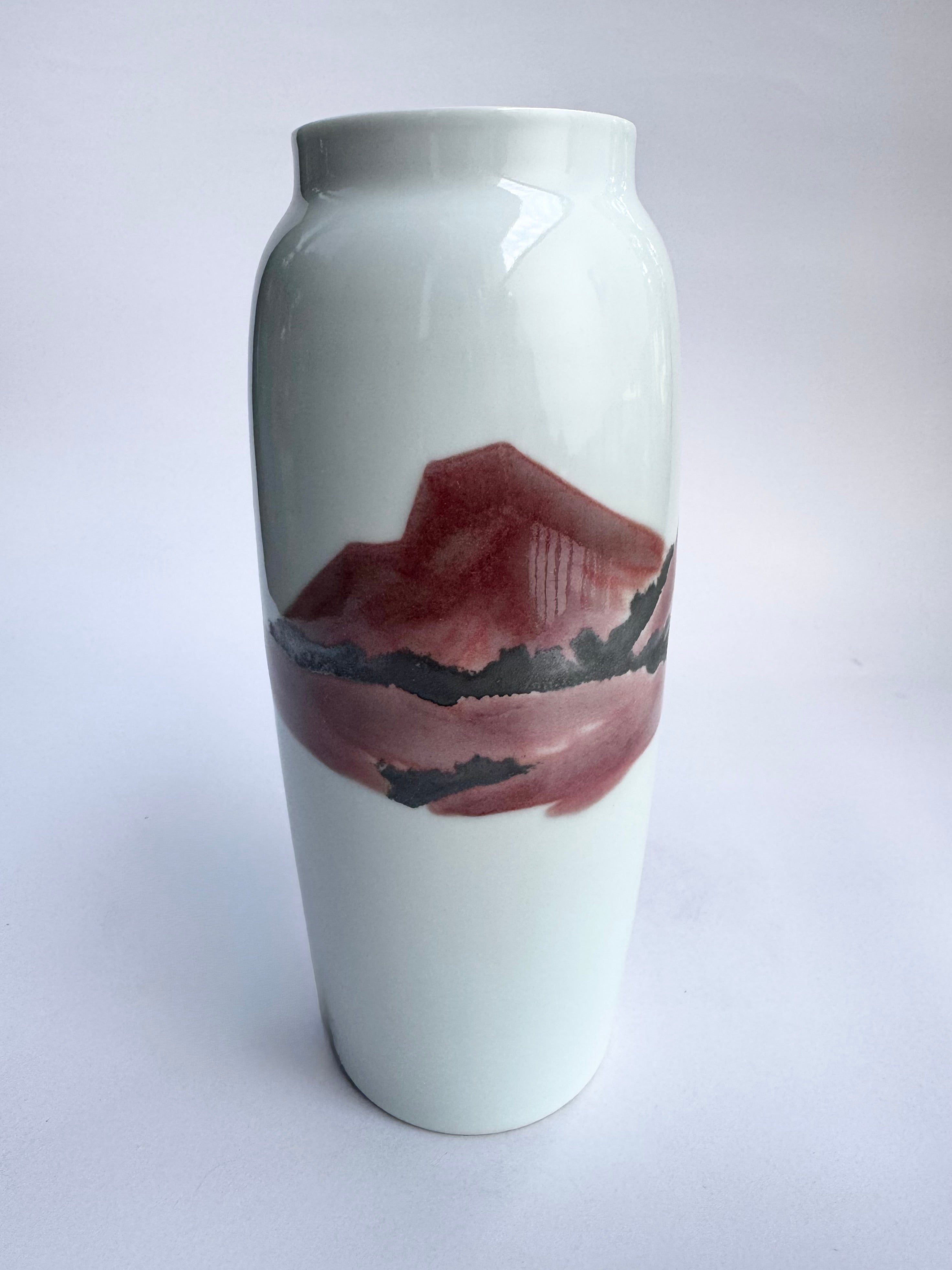 White vase with a mountain design on a white background
