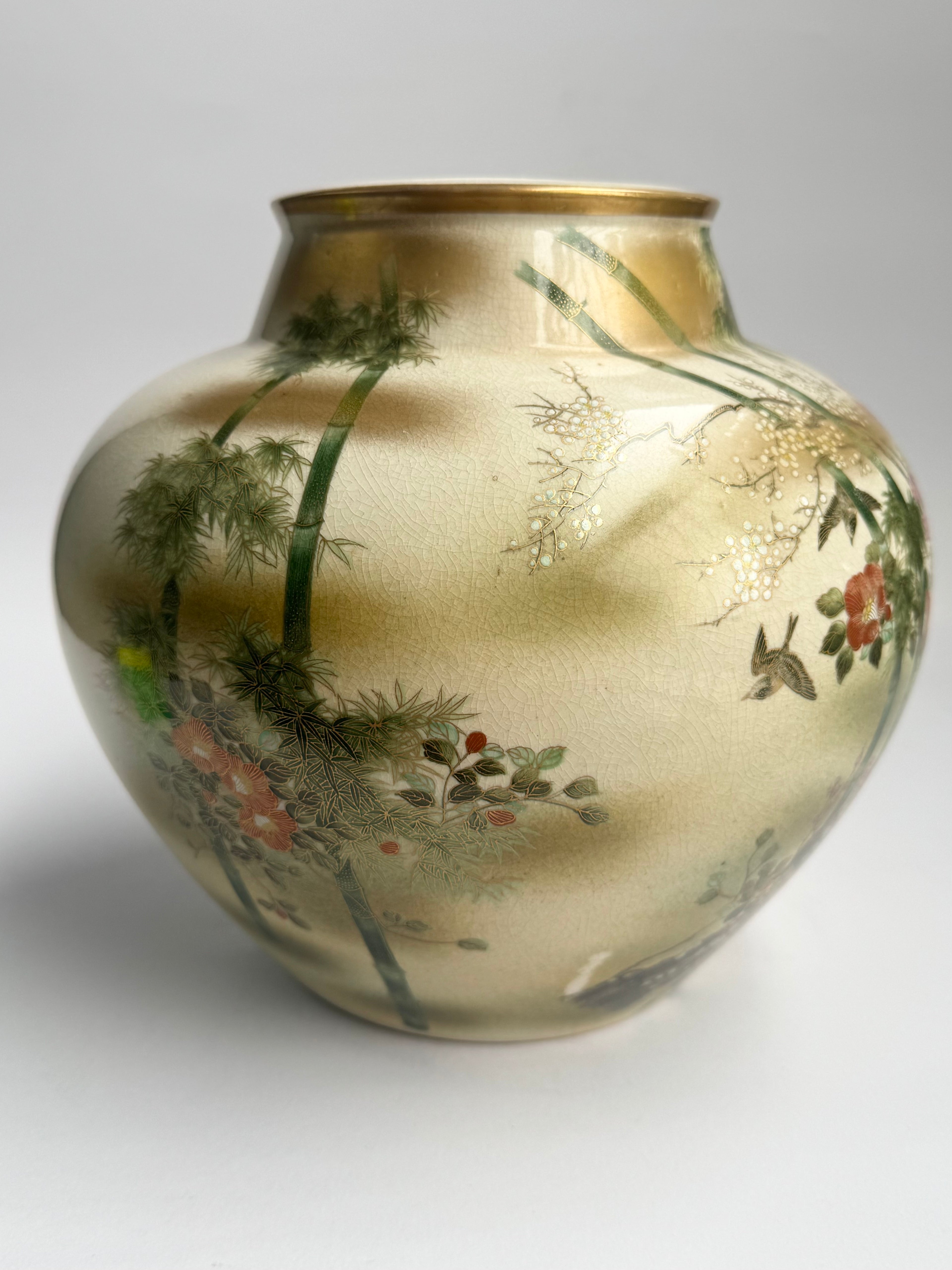 Decorative vase with floral and landscape design on a plain background