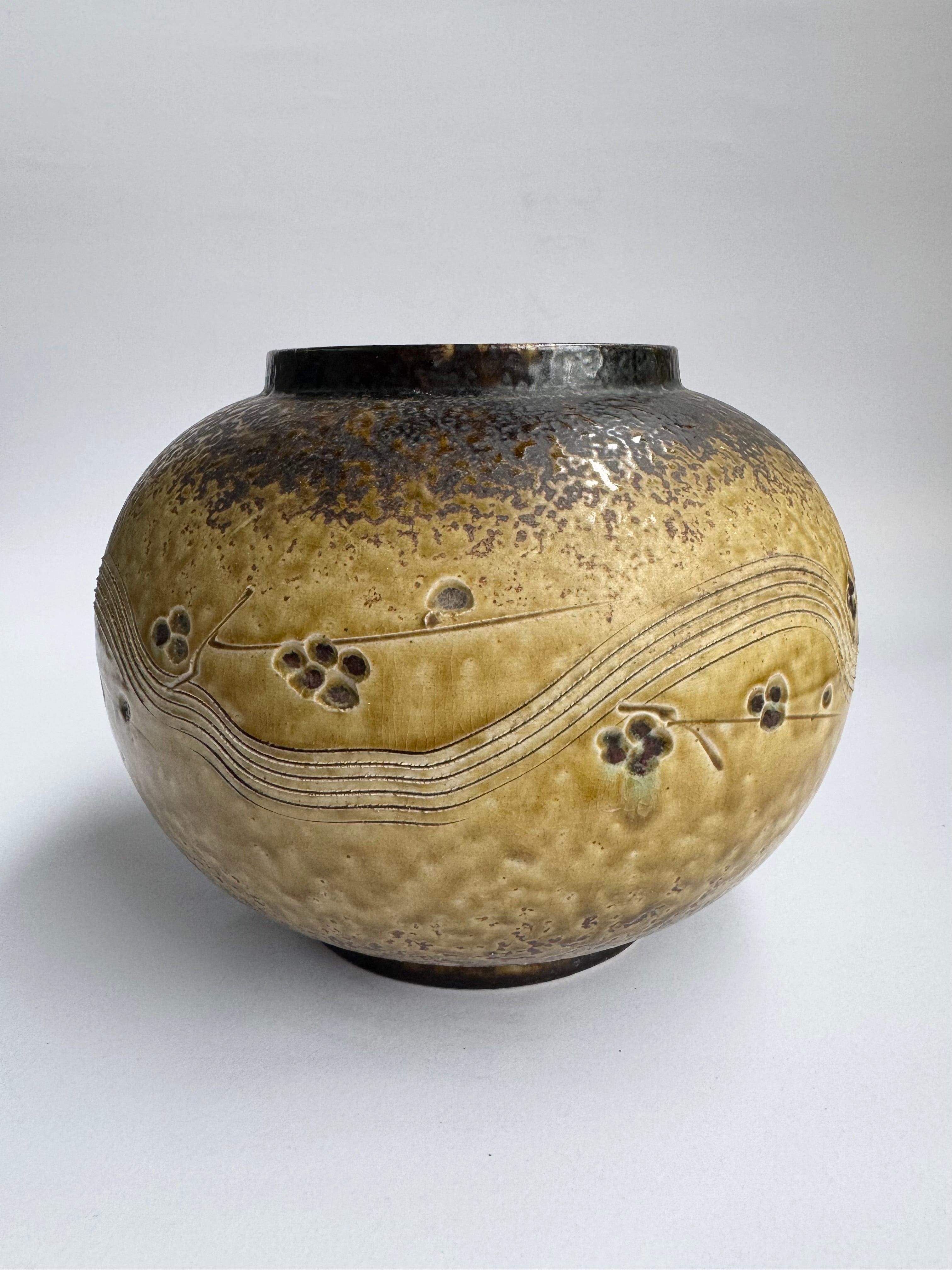 Ceramic vase with decorative patterns on a gray background