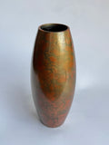 Bronze-colored vase with marbled pattern on a white background