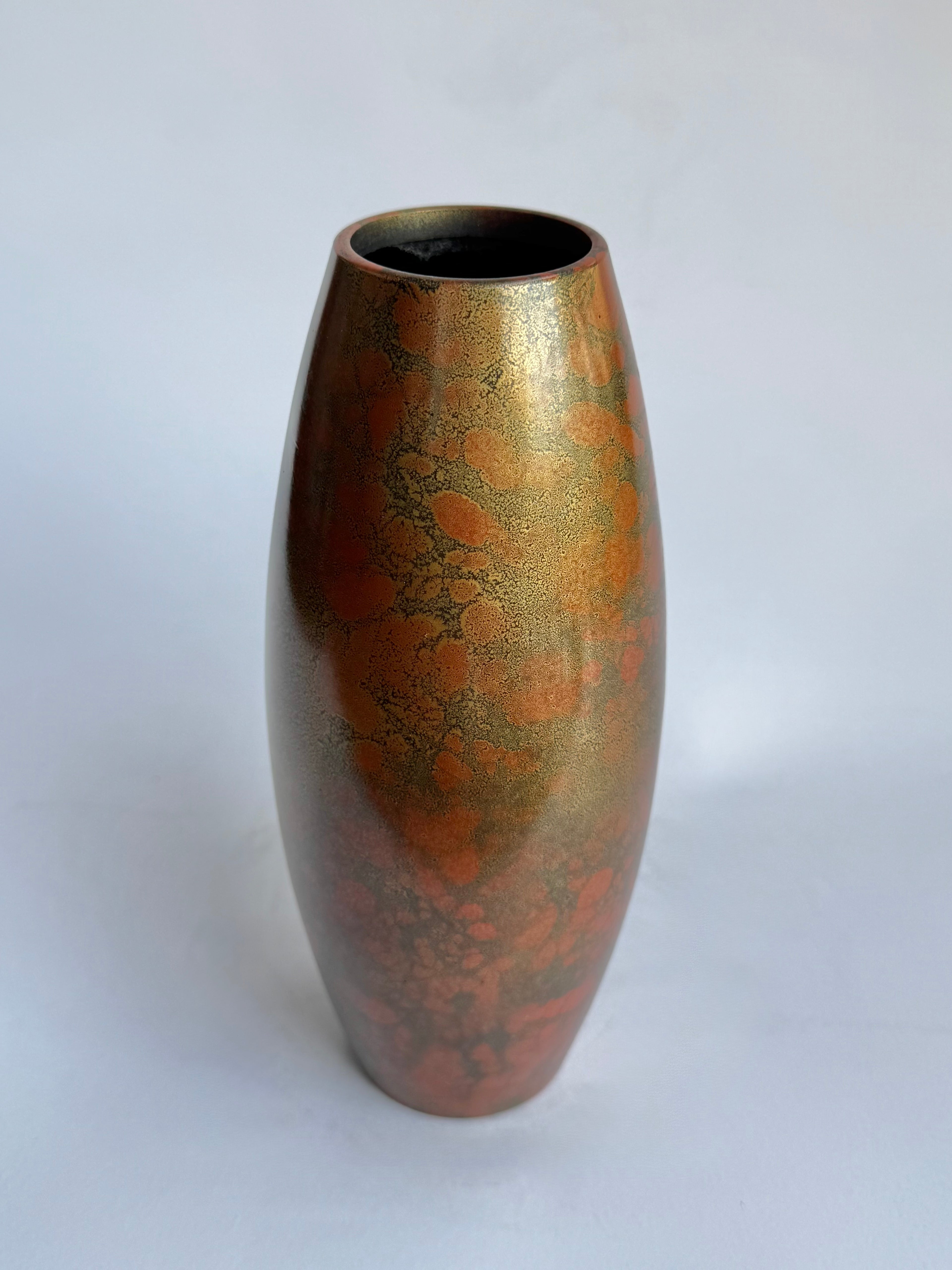 Bronze-colored vase with marbled pattern on a white background