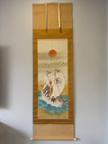 Traditional Japanese scroll with a ship and sun design on a plain wall