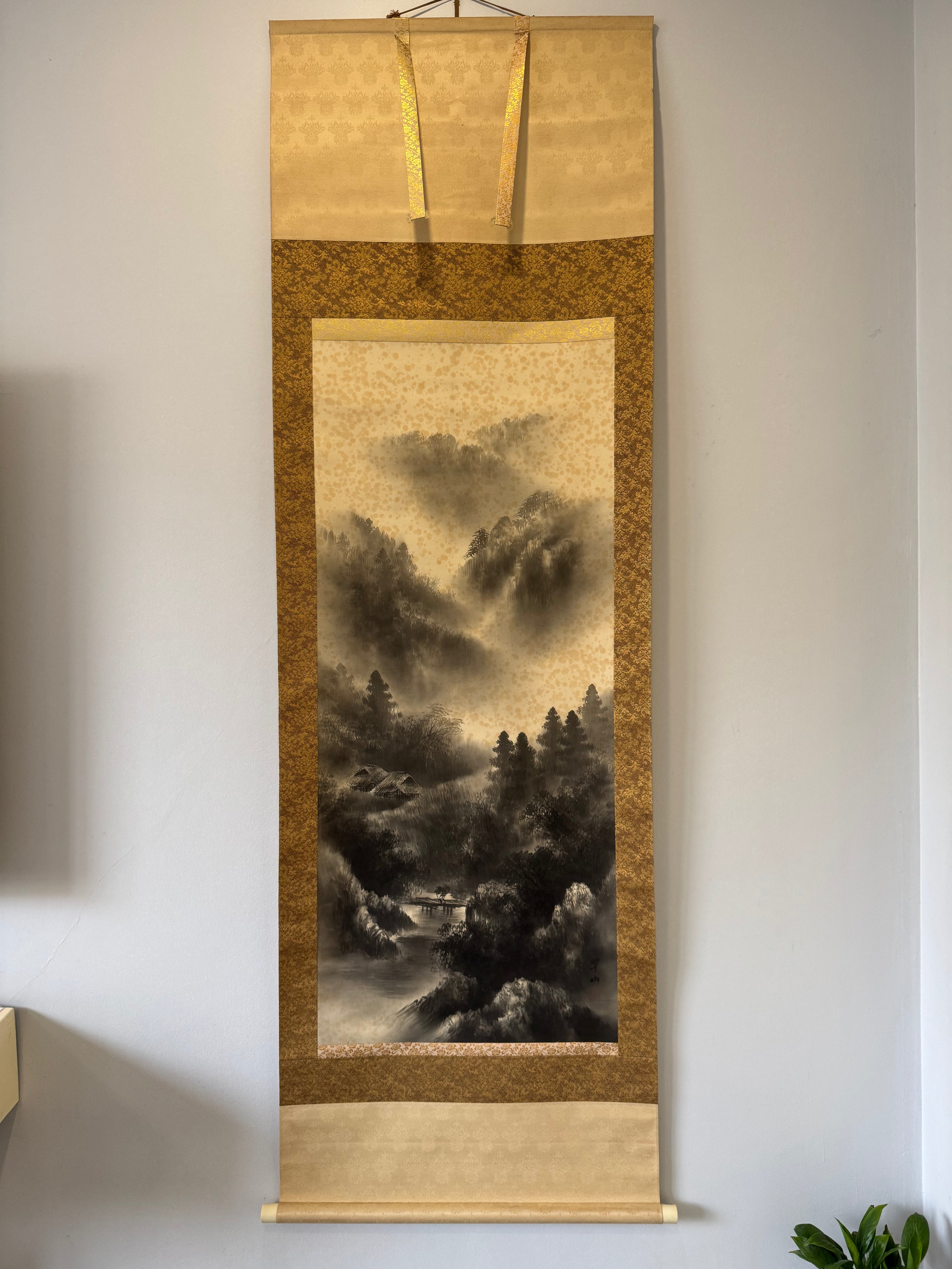 Traditional landscape scroll art on a wall