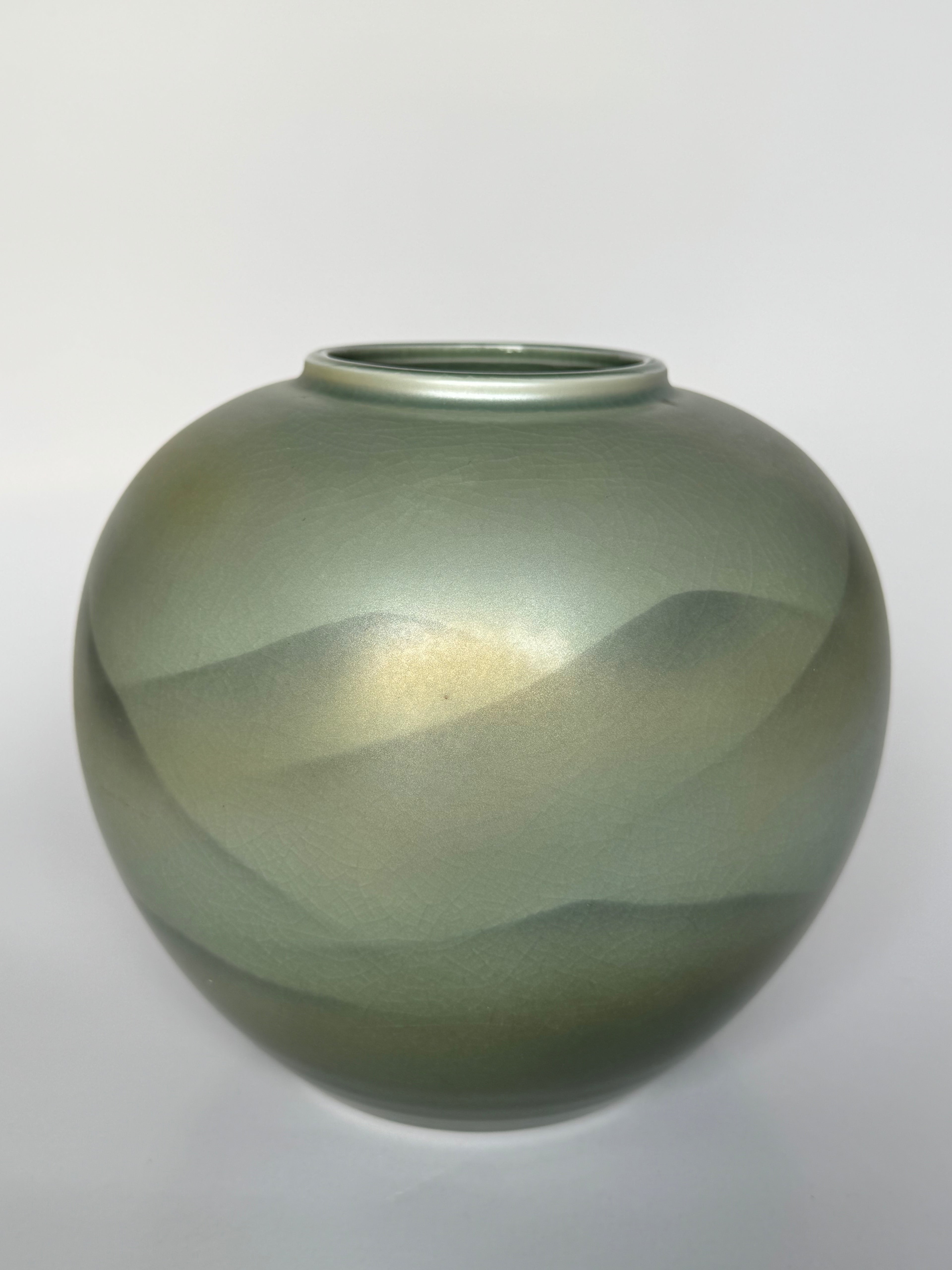 Green glass vase on a white background