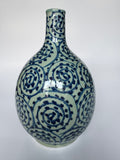 Ceramic vase with blue and white spiral pattern on a white background