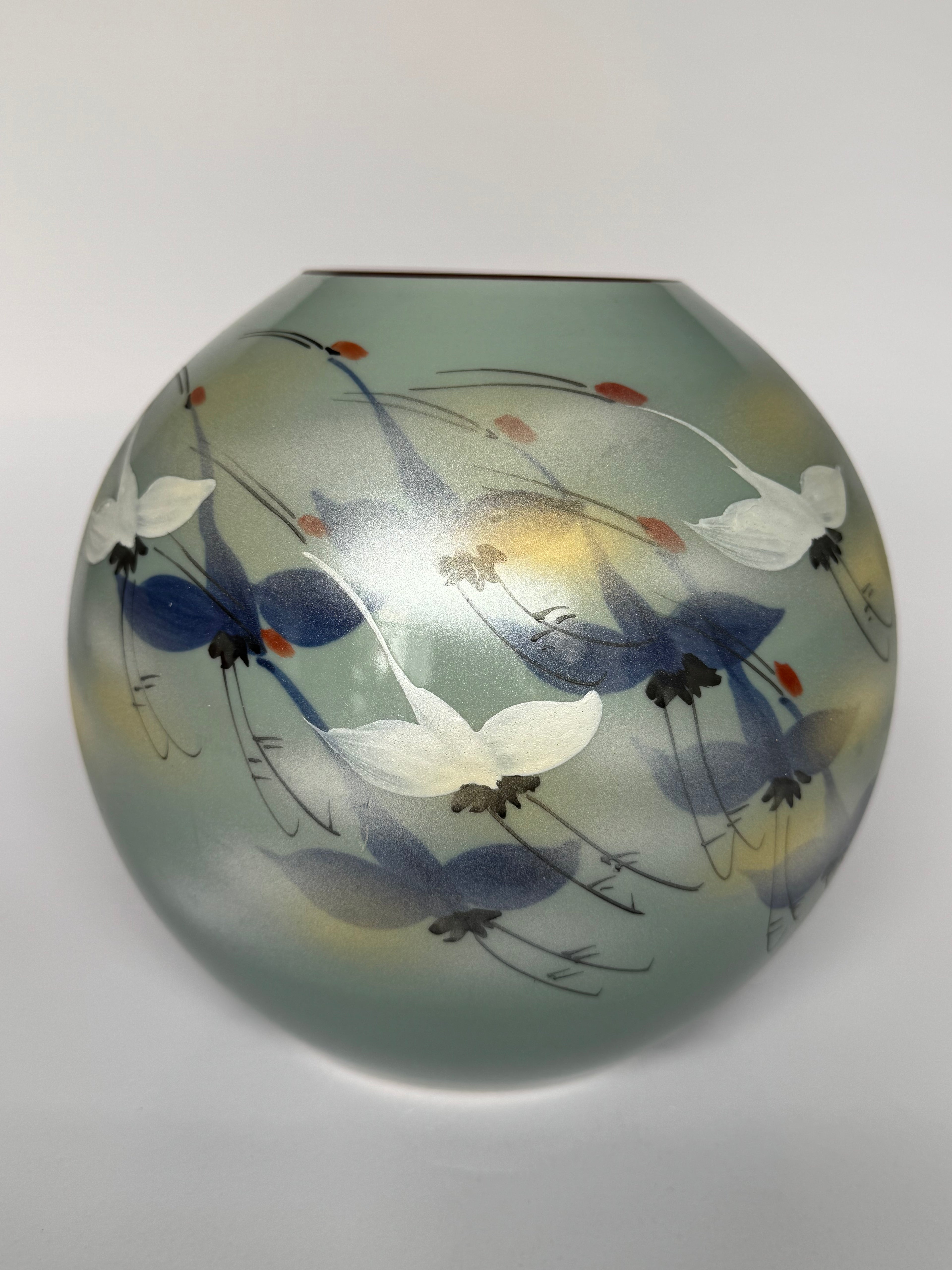 Decorative glass vase with floral and butterfly design on a white background