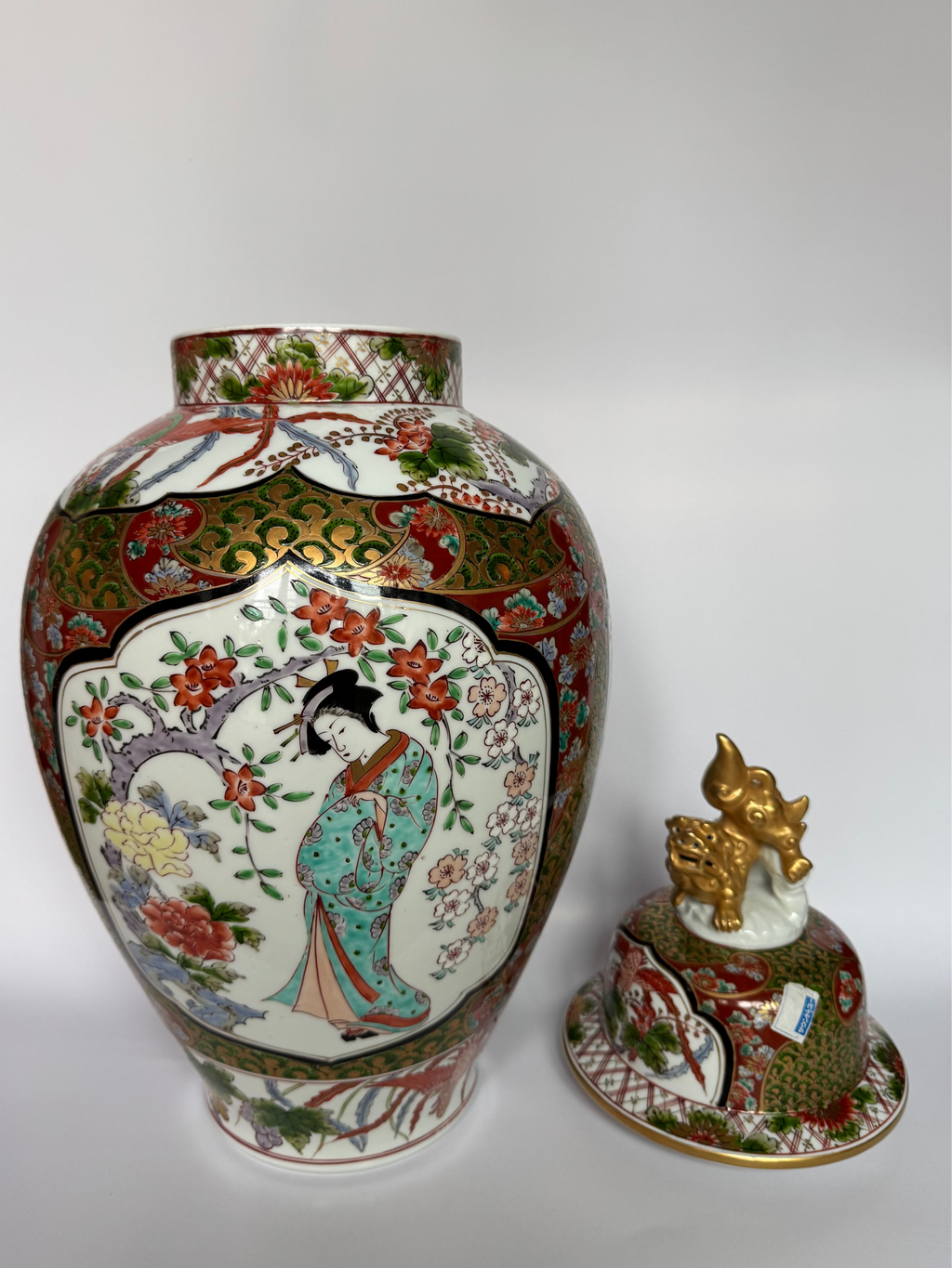 Decorative ceramic jar with intricate designs on a white background