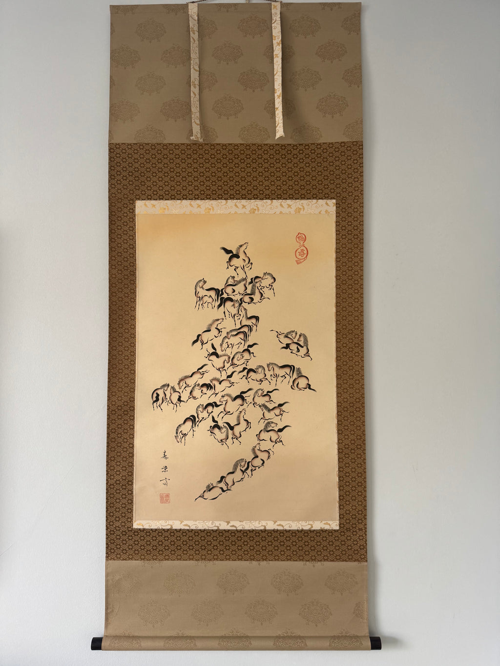 Traditional japanese scroll with artistic depiction of animals on a beige background