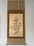 Traditional japanese scroll with artistic depiction of animals on a beige background