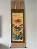 Traditional Japanese landscape scroll with Mount Fuji on a plain wall