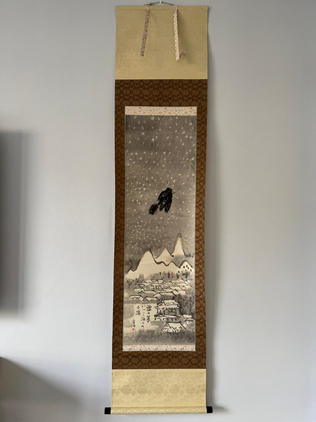 Traditional Japanese scroll with winter scene and snowflakes on a plain background