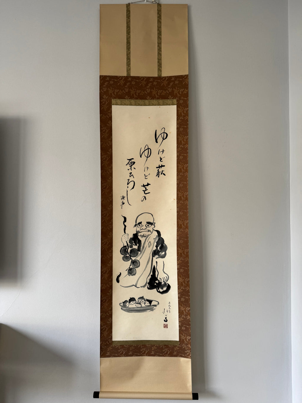 Traditional Japanese artwork on a vertical scroll with a plain background