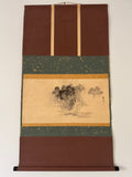 Traditional Japanese scroll with landscape design on a plain background